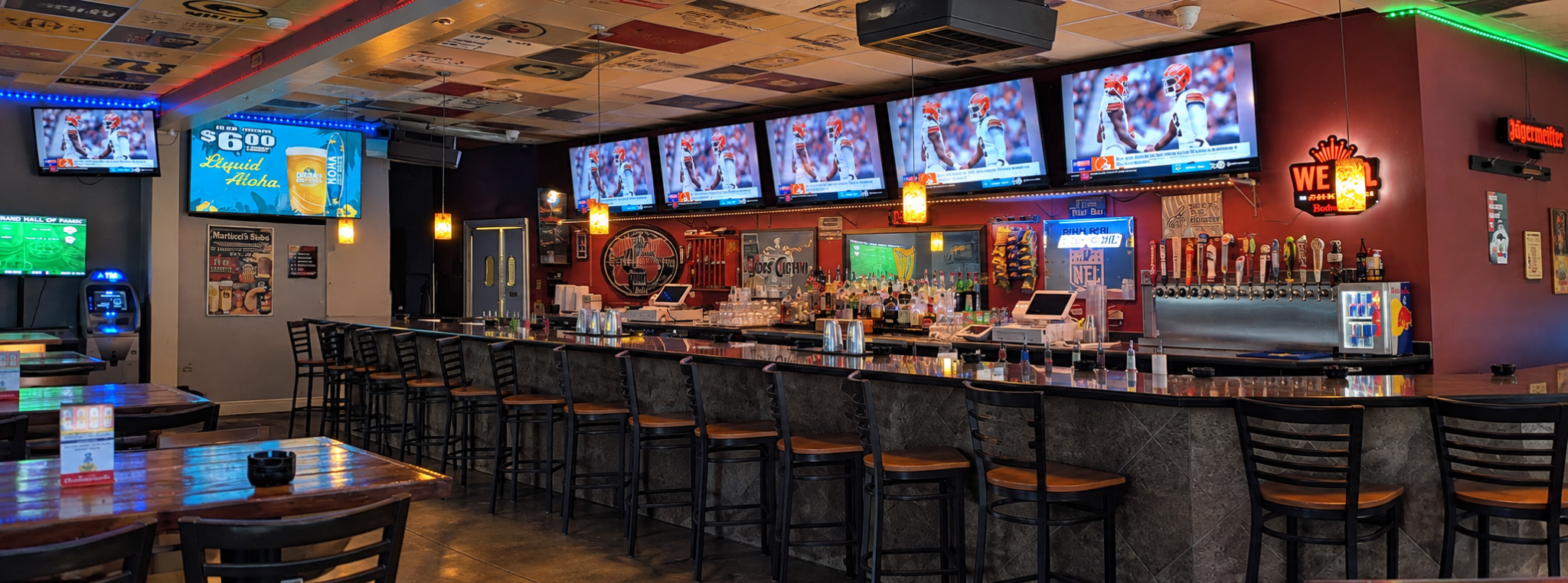Inside City Limits Bar with its long bar, seating, televisions and draft taps